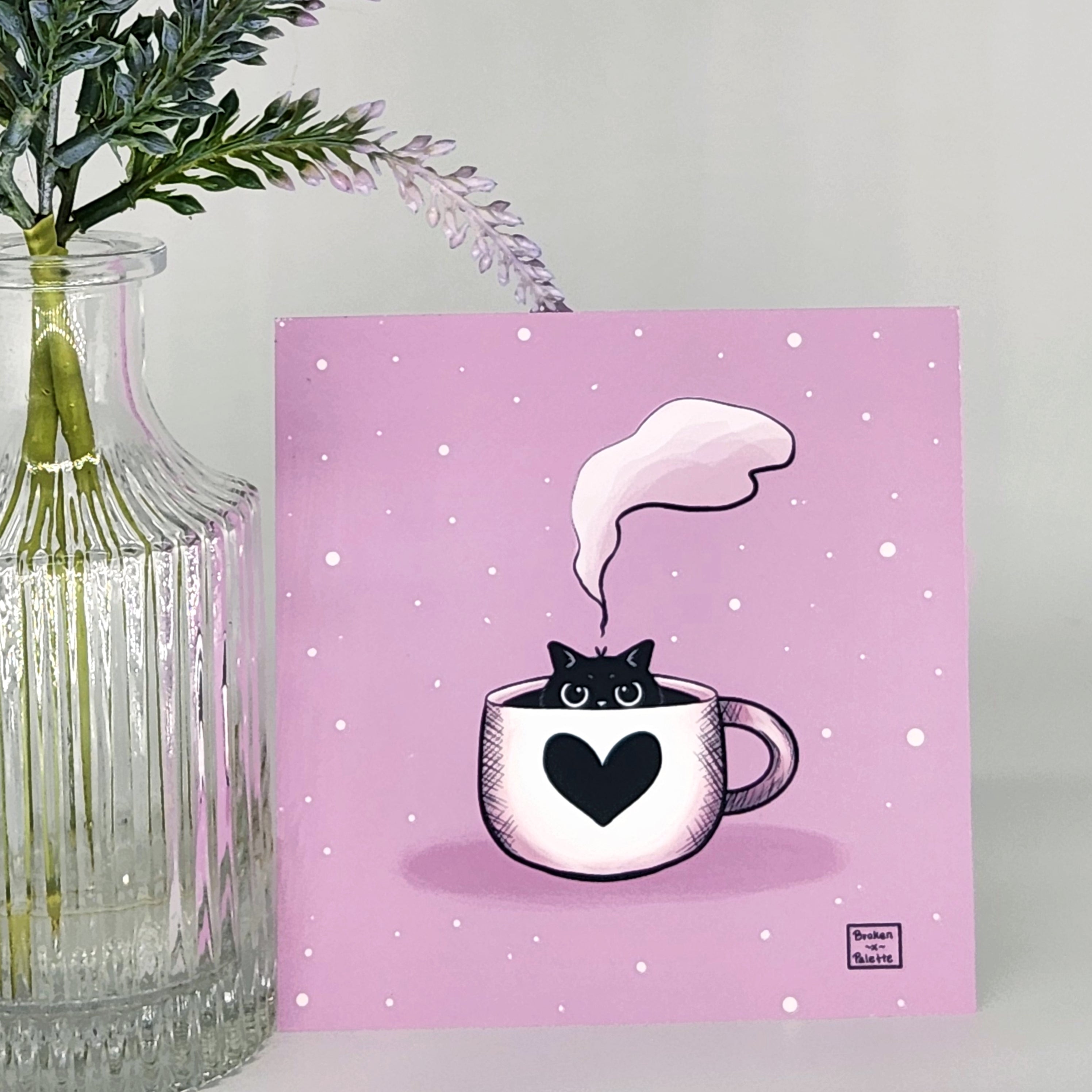 Illustration of a cat in a coffee cup with steam on a pink background, next to a clear vase with greenery.